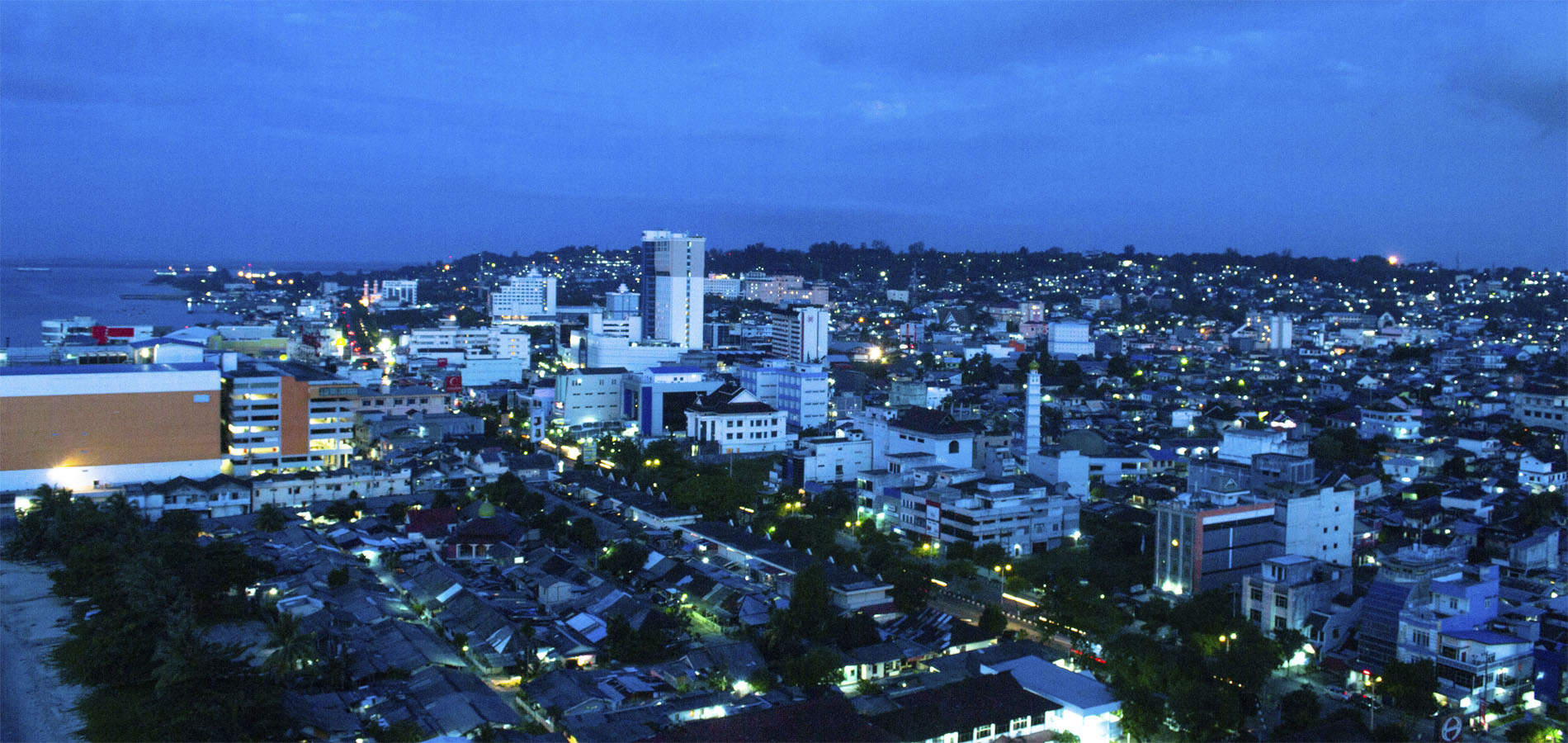 Home 1900x900 Istock Original Asia Rondreis Indonesie Vakantie Kalimantan Balikpapan avond skyline stad